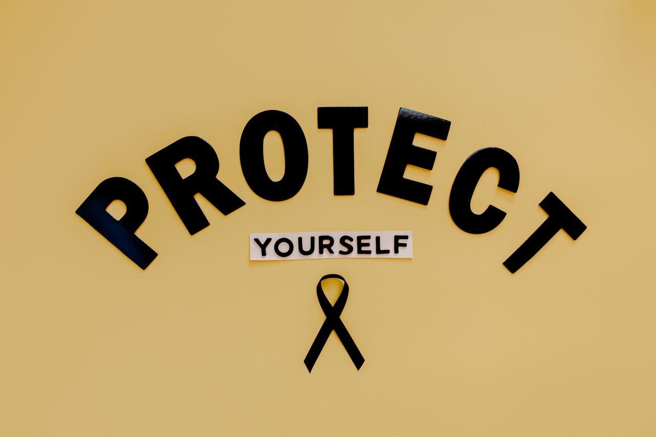 services-03 Conceptual awareness image with u0022Protect Yourselfu0022 text and black ribbon on yellow background.